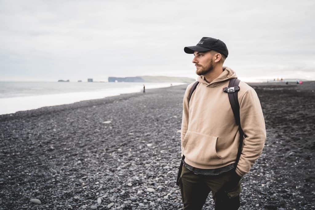 A man with a backpack on the beach 